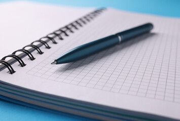 Empty white notebook with pen lie on table. Learning and education concept