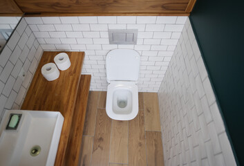 Toilet bowl stall in modern bathroom interior closeup. Minimalism in interior of toilet concept