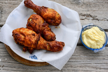  Crispy  deep fried home made    chicken   legs  Breaded  with  almond flour chicken  breast fillets  with chilly peppers and fresh   basil on wooden rustic background. Ketogenic diet food