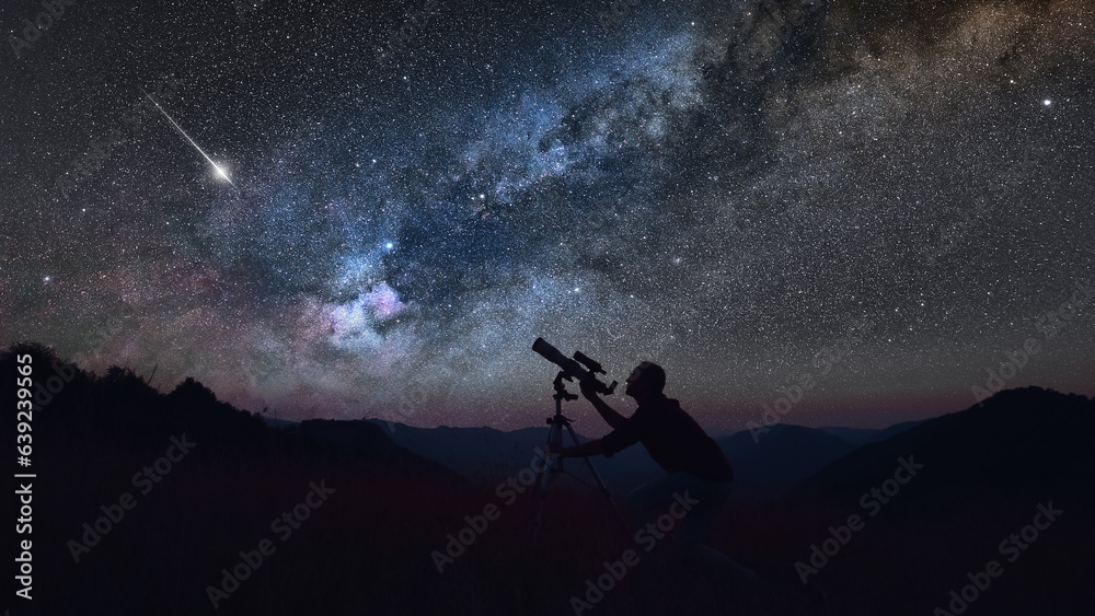 Wall mural astronomer looking at the starry skies with a telescope.