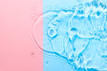 Water pink blue surface abstract background. Waves and ripples texture of cosmetic aqua moisturizer with bubbles.