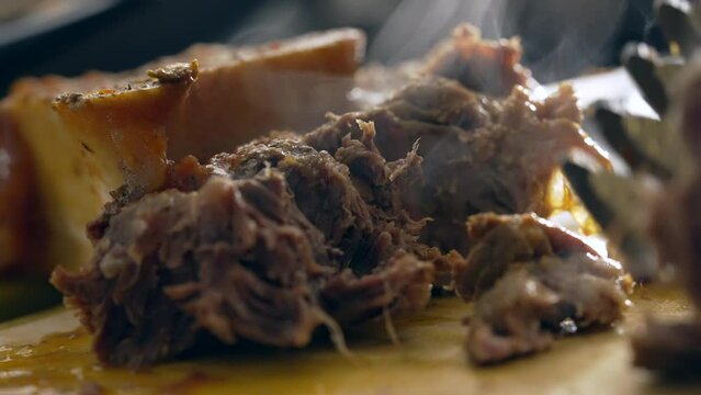 Macro close-up of hot meat, preparing and cooking meal, steam smoke coming from food