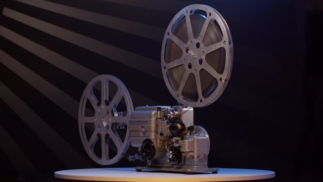 Old vintage movie projector for playing film. 16mm retro projector general view rotates. concept of an old film or cinema.