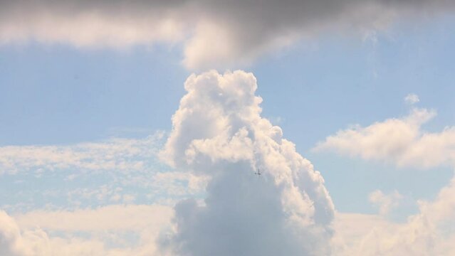a glider flying in a cloudy sky video
