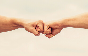 Teamwork and friendship. Partnership concept. Man giving fist bump. Bumping fists together. Fist...