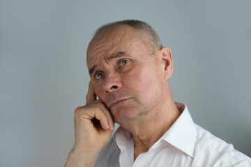 close-up of mature charismatic man, senior 60 years surprised, puzzled, shocked by news, event, bright facial expressions, overhang, concept human health, mood, human stress resistance