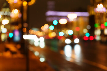 Night street lights. Blurred cars, transport and taxis and traffic on the evening city road with bright lights. Evening mood