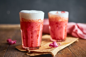 Thai style iced pink milk.Cold sweet drink Red Grenadien Sugar Syrup mix with milk and iced cube in glass