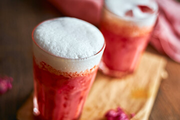 Thai style iced pink milk.Cold sweet drink Red Grenadien Sugar Syrup mix with milk and iced cube in glass