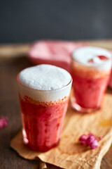 Thai style iced pink milk.Cold sweet drink Red Grenadien Sugar Syrup mix with milk and iced cube in glass