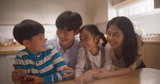 Portrait of Happy Korean Family Looking at Camera and Smiling in their Sunny Apartment. Young Parents and Two Adorable Kids Posing for a Photo, Keeping Memories, Showing Love and Support. Slow Motion