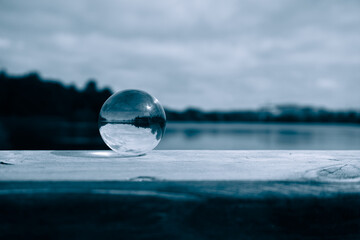 Close up of a crystal ball on wooden railing