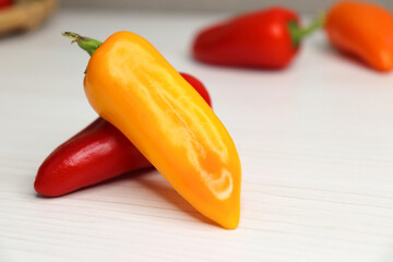 Vibrant chilli peppers. Assorted colorful varieties of hot and sweet peppers or chilies on a farm background. copy space. 