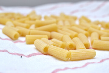 a set of dry rigatti noodles positioned on a white cloth