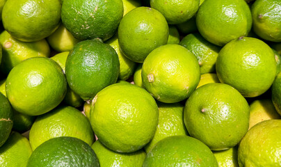 Limes. Green and ripe limes theme. Limes background.