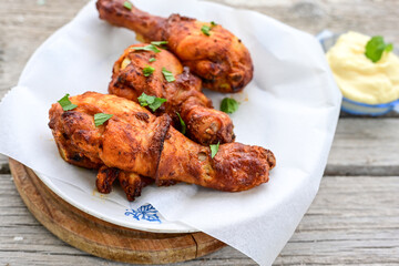  Crispy  deep fried home made    chicken   legs  Breaded  with  almond flour chicken  breast fillets  with chilly peppers and fresh   basil on wooden rustic background. Ketogenic diet food