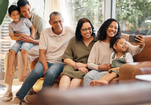 Happy family, selfie and grandparents and kids on sofa for holiday, love and relax together at home. Interracial people, mother and father with children in living room, profile picture or photography