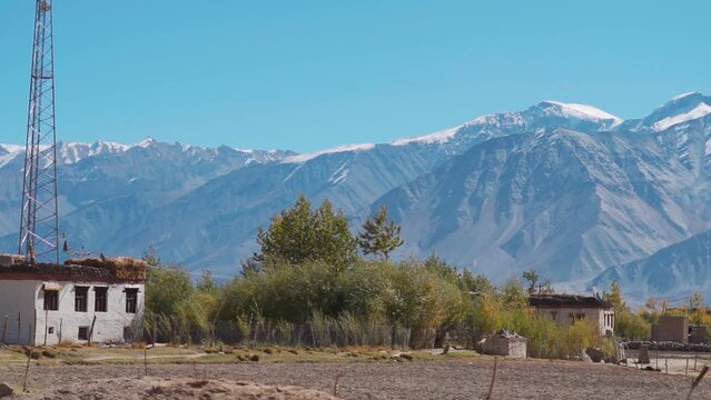 Closeup shot of traditional houses in front of the snowy Himalayan mountain range at Sani village near Padum town in Kargil District, Ladakh, India. Traditional homes in the middle of the Himalayas.