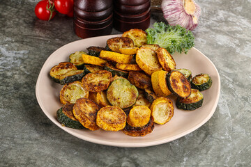 Roasted young zucchini in the plate