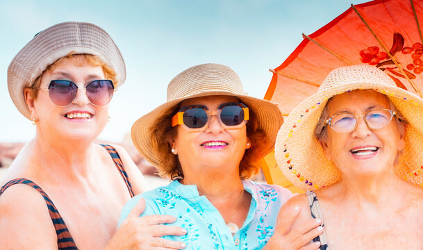 Portrait of group of friends old age senior women smiling at the camera during summer holiday vacation outdoor leisure activity. Beauty and ege people. Friendship and retirement lifestyle females