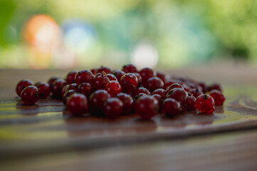 Red currant on brown wooden surface, table, close up view. Selective focus