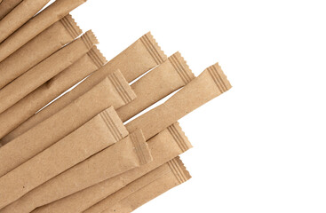 heap of sugar sticks, sugar in paper kraft packaging, mock up for design isolated on white background with clipping path