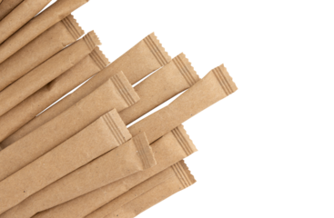 heap of sugar sticks, sugar in paper kraft packaging, mock up for design isolated on white background with clipping path