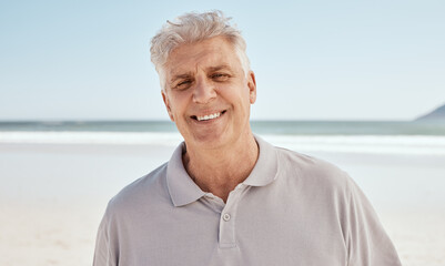 Fototapeta na wymiar Portrait, beach and old man with retirement, happy and travel with summer vacation, Canada and wellness. Face, senior person or traveler on seaside holiday, weekend break or relax with peace or smile