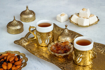 Ramadan party table with tea and sweets. Muslim holiday background