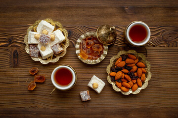 Ramadan party table with tea and sweets. Muslim holiday background