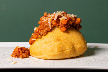 Montanara napoletana fritta e condita con ragù alla bolognese e formaggio grattugiato servita come...