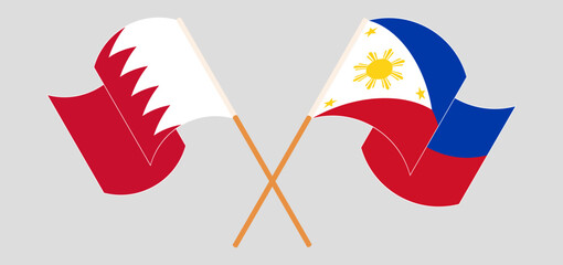 Crossed and waving flags of Bahrain and the Philippines