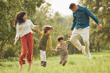 Holding hands, park and parents jump with children in nature for playing, bonding and fun together...