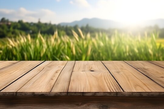 Wooden plank floor table and empty front, and natural rice fields, fresh atmosphere, sunlight in the early morning background,