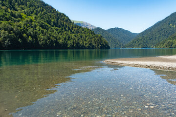 Beautiful mountain Lake Ritsa. Lake Ritsa in the Caucasus Mountains, in the north-western part of Abkhazia, Georgia, surrounded by mixed mountain forests and subalpine meadows