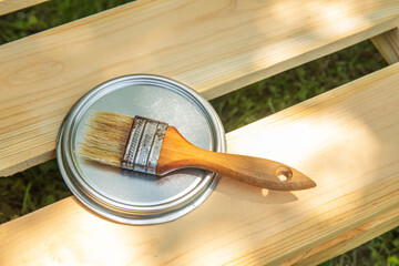 Image of paint brush with primer on the wooden table. painting and renovation repairing concept