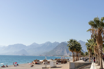 seashore in Antalya. People are relaxing on the beach. palm trees