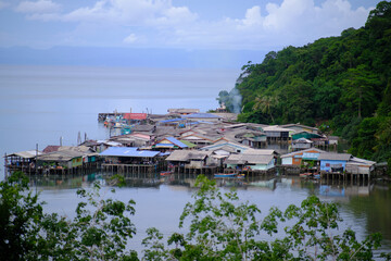 In the embrace of a Koh Kood, Thailand fishing village during sunset, the scene transforms into pure amazement.
