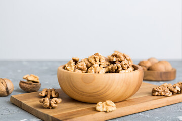 Fresh healthy walnuts in bowl on colored table background. Top view Healthy eating bertholletia concept. Super foods