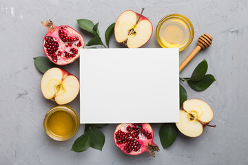 Flat lay composition with Blank flyer poster and symbols jewish Rosh Hashanah holiday attributes on colored background, New Year holiday Traditional. Top view with copy space mock up