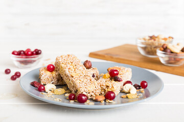 Various granola bars on table background. Cereal granola bars. Superfood breakfast bars with oats, nuts and berries, close up. Superfood concept
