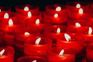 Close-up of red candles in the cathedral of the city of Como in Italy