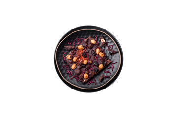 Handmade chocolate with berries, nuts and spices on a dark background