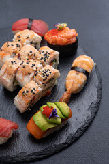 Delicious rolls on a dark background. Japanese cuisine. Close up  