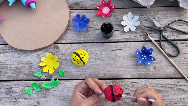 how to make flowers and lady bug from recycling egg boxes. Zero waste concept.