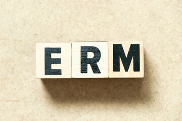 Alphabet letter block in word ERM (Abbreviation of Enterprise risk management) on wood background