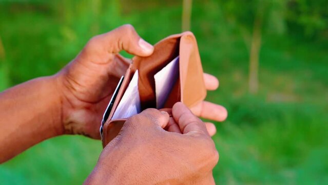 Closeup of a boy with an empty wallet, No balance and cash in the wallet, poor economy and wealth of population