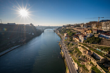 Sunset over the duero river bridge in Oporto, Portugal