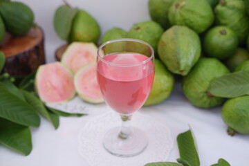 Fresh guava juice in a glass and fresh guava fruit.