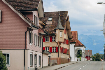 Fototapeta na wymiar Alpnachstad, Switzerland - August 9, 2023: Beautiful facades of the Swiss Alpnachstad